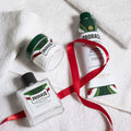 Proraso shaving gift set with pre shave cream, shaving cream, and aftershave cream on white towels.